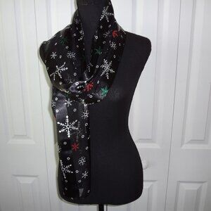 Holiday Black Scarf with White, Green and Red Snowflake Designs.